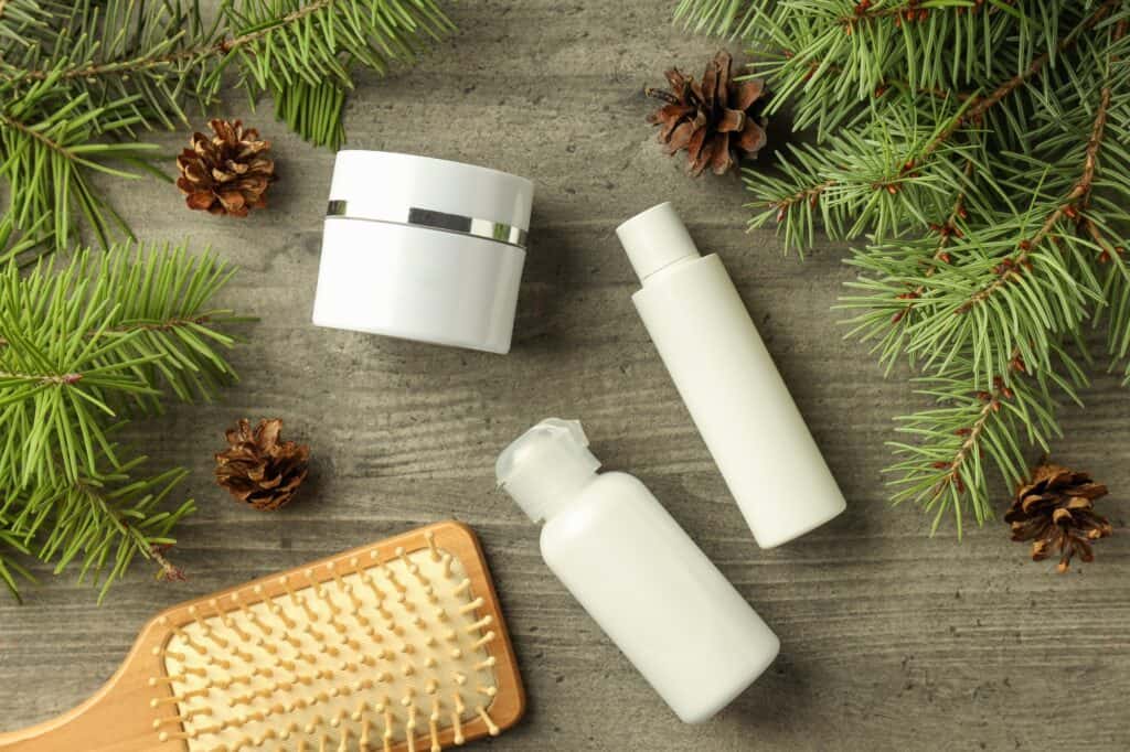 Composition with winter cosmetic products on gray textured table
