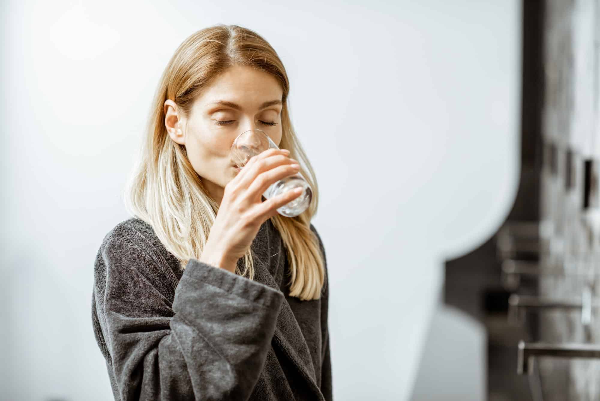 Woman drinking mineral water at the pump-room