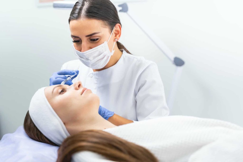 Dermal filler being injected into a patient forehead