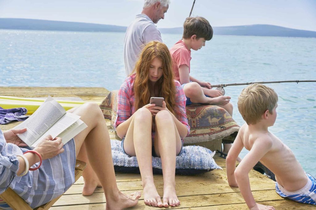 Family relaxing on houseboat sun deck, Kraalbaai, South Africa