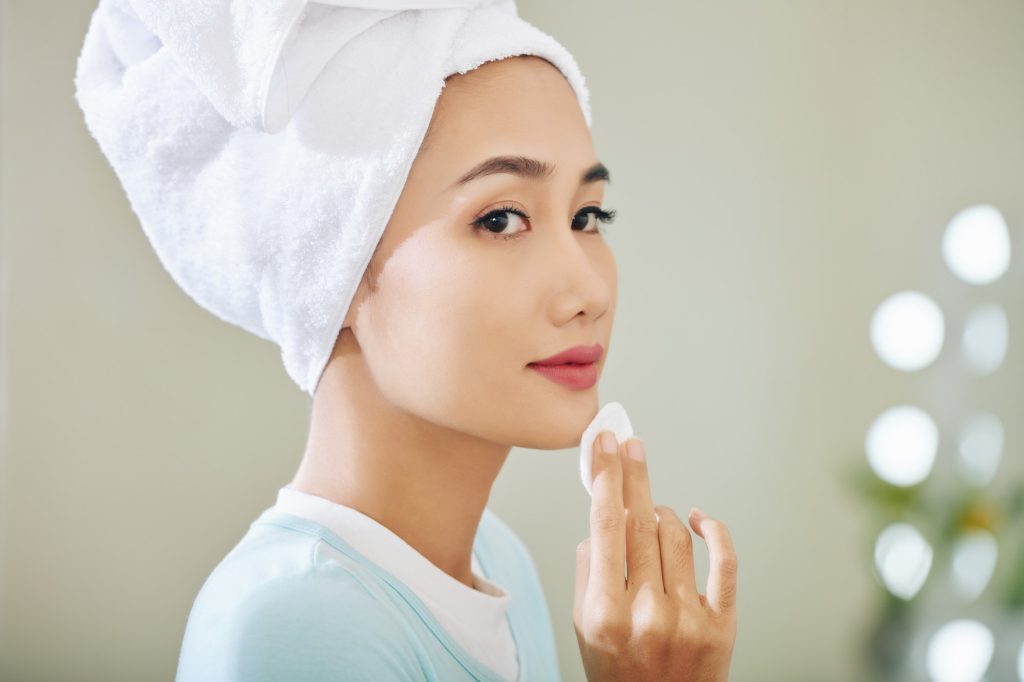 Woman applying face toner