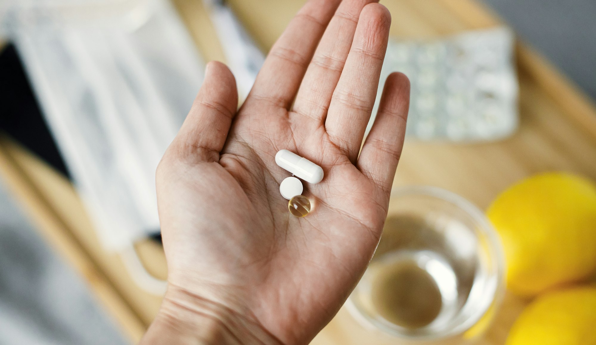 Supporting immune system in season of flu or coronavirus. Vitamin D, C and zinc in senior hand